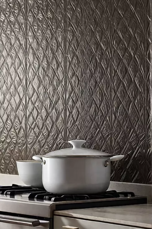 Textured metallic wallpaper backsplash in a kitchen